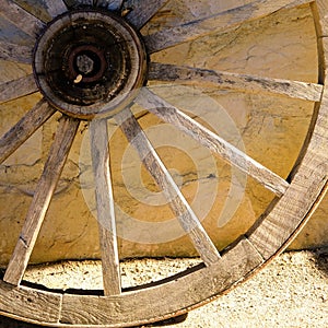 Detail of a wagon wheel against a wall