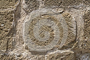 detail of wall built with stone blocks carved by hand