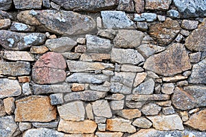 Detail of a wall of irregular and colorful stones