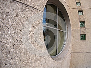 Detail of a wall of an office building with a round window