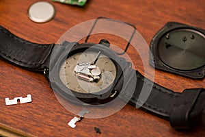 Detail of watch machinery on the table, on a wooden table