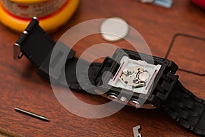 Detail of watch machinery on the table, on a wooden table