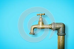 Detail of a water brass faucet isolated on solid color background - image with copy space
