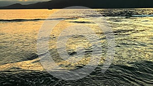 Detail of waves on gravel beach spit at sunset in Port San Juan, Port Renfrew, British Columbia, Canada