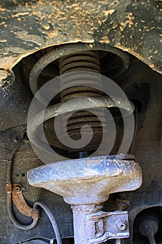 Detail of wheel coil damper spring suspension on 13-years old car