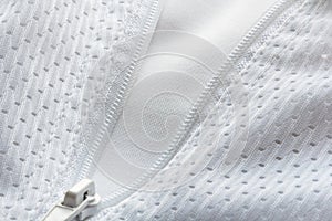 Detail of white breathable sportswear with a zipper