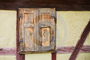 Detail of the window and wall front facade of old traditional half timbered framing house facade in Germany.