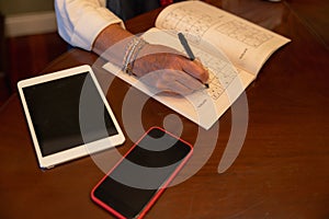 Detail of a woman making sodokus with the help of technology