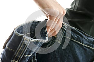 Detail of woman skinny waist in too large old jeans