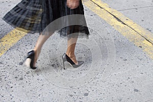 Detail of Womens black high heels and bag in New York photo