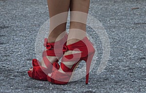 Detail of Womens red high heels in New York