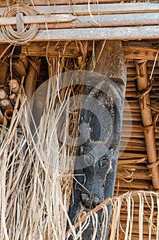 Detail of wood carving of black cow at traditional Fon`s palace in Bafut, Cameroon, Africa