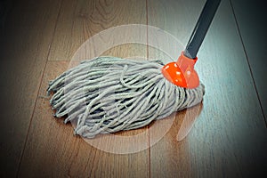 Detail of wooden floor cleaning with mop