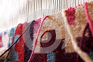 Detail of a woolen carpet on a loom