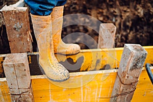 Detail of workwear. Construction worker pouring cement on construction site