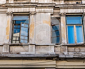 Detail of an worn out old building with windows in the center of Bucharest