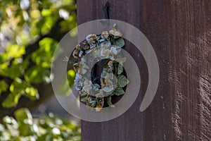 Detail of a wreath of paper colored flowers