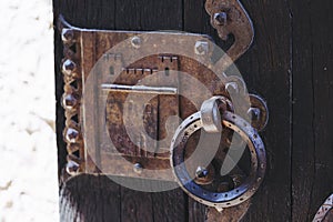 Detail of wrought iron decoration on an old wooden door in a castle