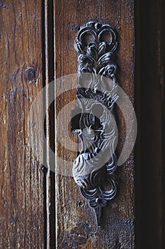 Detail of wrought iron decoration on an old wooden door in a castle