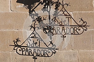 Detail of wrought iron letters and shades of lamppost of Hostelry from Ubeda