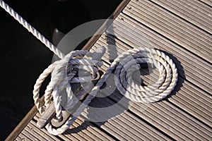 Detail yacht rope around cleat on jetty