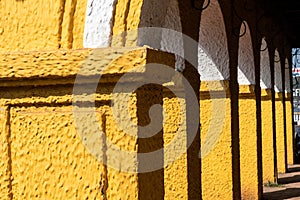 Detail of yellow arches of an old Portuguese era building