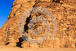 Detail of the yellow colored mountain rocks in the Wadi rum desert in Jordan at early-morning