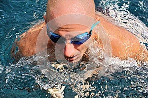 Detail of young man swimming