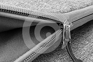 Detail of a zipper on an open bag.