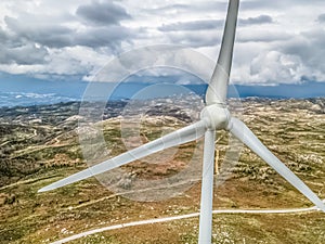 Detailed aerial view, by drone, of a wind turbines on top of mountains