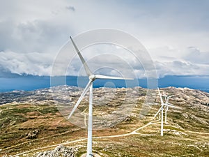 Detailed aerial view, by drone, of a wind turbines on top of mountains