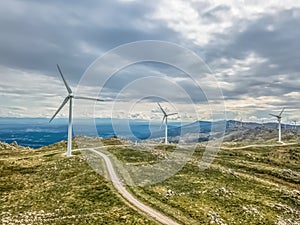 Detailed aerial view, by drone, of a wind turbines on top of mountains
