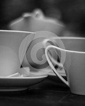 DETAILED BLACK AND WHITE PHOTO OF TEACUPS AND TEAPOT