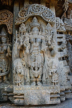 Detailed carvings of deity with ornaments at Somnathpur, Karnataka, India photo