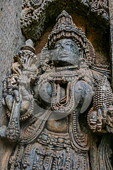 Detailed carvings of deity with ornaments and weapons at Somnathpur, Karnataka, India. photo