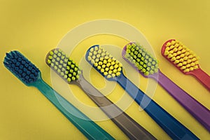 Detailed close up of different colored toothbrushes in a dentist