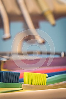 Detailed close up of different colored toothbrushes in a dentist