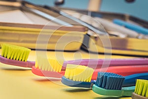 Detailed close up of different colored toothbrushes in a dentist
