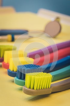 Detailed close up of different colored toothbrushes in a dentist