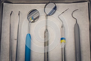Detailed close up of different dental instruments and tools on a