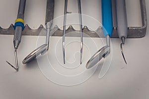 Detailed close up of different dental instruments and tools on a