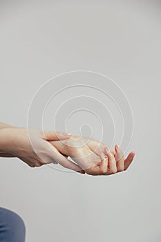 Detailed close up of hands with natural nails and wrist on white background