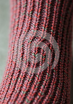 Detailed Close Up of Red and Green Knitted Fabric Texture