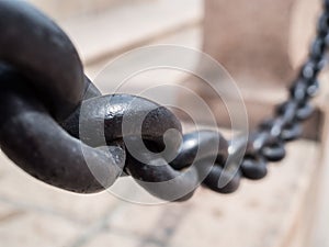 Detailed close up of rusted links in a large chain fence