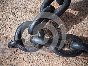 Detailed close up of rusted links in a large chain fence