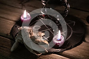 A detailed close-up shot of two lit pink candles with a dark, mystical background, emphasizing a ritualistic theme. photo