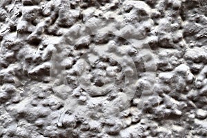 Detailed close up of a structured concrete wall with some cracks