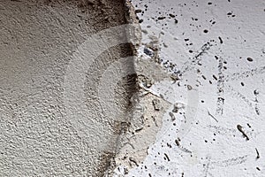 Detailed close up of a structured concrete wall with some cracks