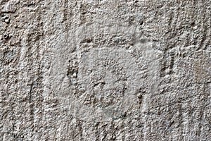 Detailed close up of a structured concrete wall with some cracks