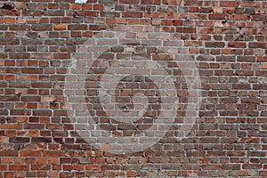 Detailed close up view on an aged and weathered red brick